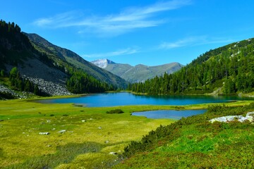 View of Karwasser lake at the shore of an alpine meadow in High Tauern mountains Central Eastern Alps, Austria