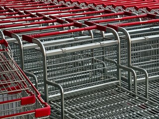 A row of shopping carts is neatly lined up in a straight row