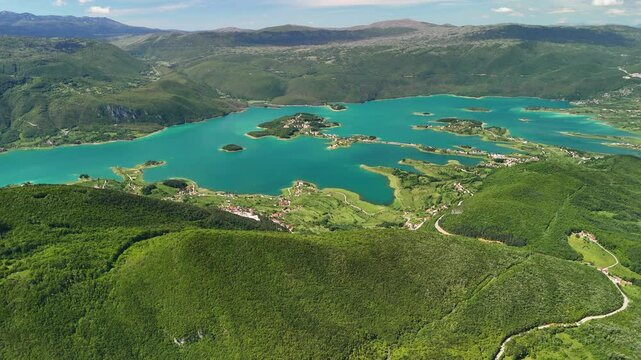 Aerial view of Rama Lake, a beautiful and breathtaking lake with many small islands. It is truly a stunning sight, surrounded by lush green mountain slopes. Bosnia and Herzegovina. 