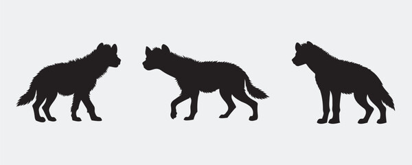 Three black silhouettes of wild canines, including a hyena and wolves, in side profile on a clean white background, perfect for educational or design purposes