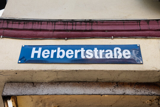 Herbertstrasse street name sign close-up in Hamburg, Germany. Road signage at the intersection in the red-light district of St. Pauli. Famous place known for prostitutes in the windows of the houses.