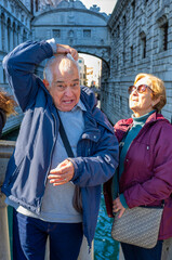 Tourist reacting after being hit by pigeon droppings near the Bridge of Sighs, Venice