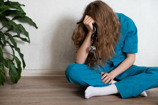 Medical student studies diligently while feeling overwhelmed at a desk in a quiet study space