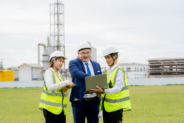 Engineers coordinating project execution in oil refinery setting.