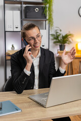 Happy Caucasian stylish young businessman communicating with customer by phone smartphone, working...