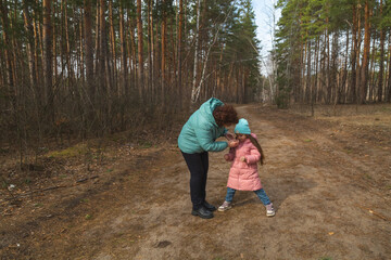 Grandmother with granddaughter walking in nature in the forest
