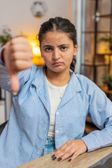 Dislike. Upset unhappy woman showing thumbs down sign gesture, expressing discontent, disapproval...