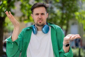 I don't know what to say. Confused young man feeling embarrassed about ambiguous question, having...