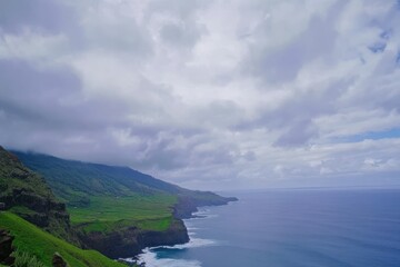The sea is calm and the atmosphere is gloomy