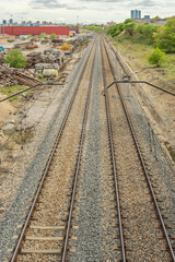 The construction of a railway track begins with site preparation, which involves soil compaction