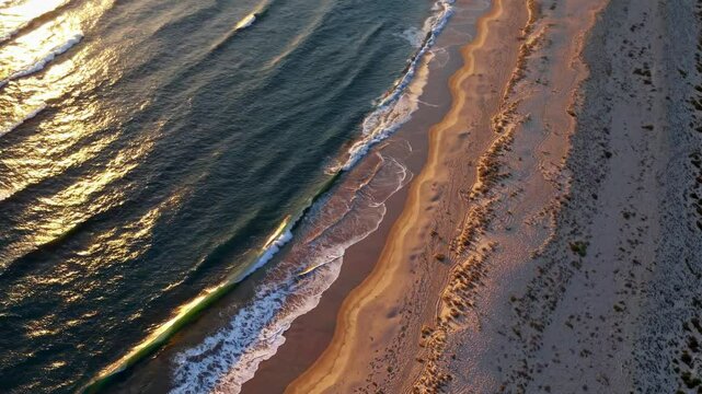 Sunset over empty sandy coastline