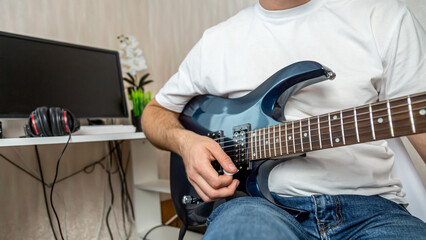 Guitar music. The performer plays. Practice chords. Male performer hands with fingers studying...
