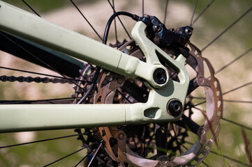 Close-up of mountain bike brake disc part. Technical expertise of bike shop service in the open air. Mountain bike parts