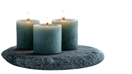 Three Lit Blue-Gray Aromatherapy Candles on a Smooth Zen Stone Creating a Peaceful Spa Mood