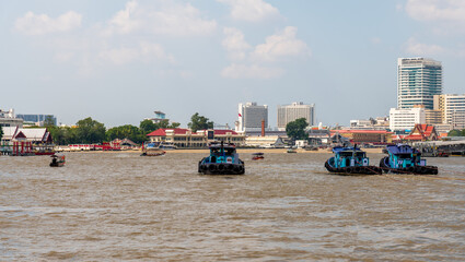 A serene and tranquil river scene featuring boats amidst a beautiful cityscape in broad daylight