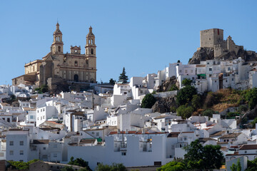 Panoramic view of the beautiful white village of Olvera with the church and the castle at sunset. Cadiz, Andalucia, Spain.