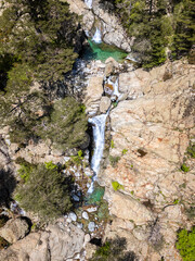 Aerial view of the Cascade des Anglais on the L'Agnone river flowing through the forest and mountains along the GR20 trail at Vizzavona on the Mediterranean island of Corsica
