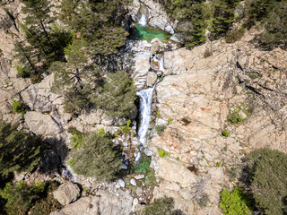 Aerial view of the Cascade des Anglais on the L'Agnone river flowing through the forest and mountains along the GR20 trail at Vizzavona on the Mediterranean island of Corsica
