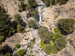 Aerial view of the Cascade des Anglais on the L'Agnone river flowing through the forest and mountains along the GR20 trail at Vizzavona on the Mediterranean island of Corsica
