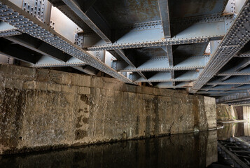 Underside of the railway bridge where the Great Western Main Line crosses the Grand Union Canal in Hayes, West London, UK.