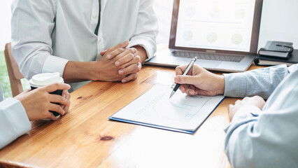 Asian couple meeting with financial advisor to analysis and discussion about investment of new...