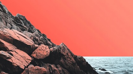 Fototapeta premium Vibrant Sunset Over Rocky Shoreline with Calm Ocean Waters and Dramatic Color Contrast