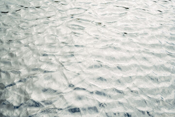 The water is calm and still, with ripples forming on the surface
