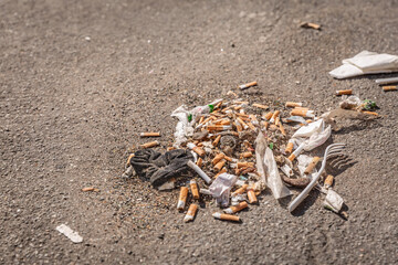Garbage, litter and cigaret buds on a street, environmential and social issue concept with littering