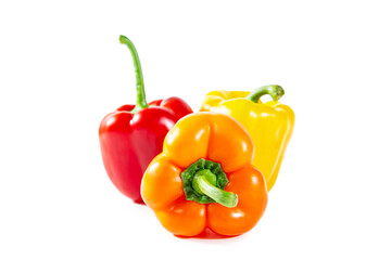 Fresh juicy shiny red, yellow and orange bell peppers. Isolated on white.