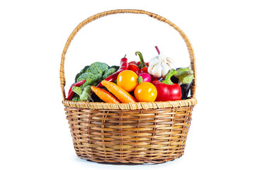 Fresh shiny multi-colored vegetables in a wicker basket.