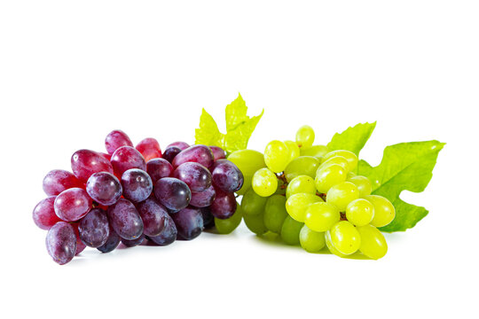 Bunches of green and red juicy grapes with leaves isolated on white.