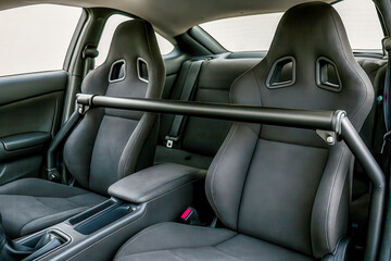 Harness bar reinforcing back seats of tuned sports car