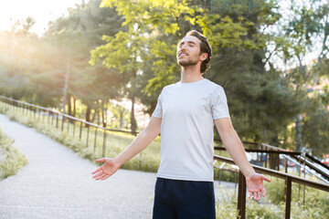 Man in city park shows mental well-being after physical training