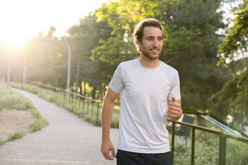 Man running in park with good weather and energy