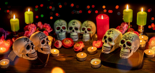 Skulls with decor for the holiday Day of the Dead. Dia de los Muertos altar surrounded by...