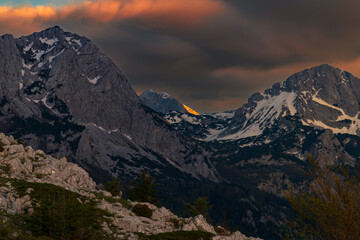Sutjeska National Park in Bosnia and Herzegovina. Sunset in the mountains of Bosnia in the area of Prijevor and Veliki Maglic. Illuminated mountain massif on the border with Montenegro