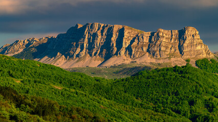 rock massif in the Sutjeska National Park in Bosnia and Herzegovina at sunset. Green blooming...