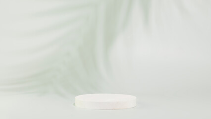 White round empty podium for presentation, advertising or montage your products on light blue background with palm leaf shadow. Concept of scene stage for natural products or promotion sale