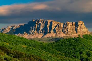 rock massif in the Sutjeska National Park in Bosnia and Herzegovina at sunset. Green blooming...