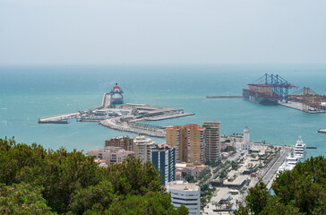 Title: Detailed view of the cruise terminal in Málaga, with Virgin Voyages ship and calm turquoise waters surrounding the port.