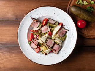 salad with meat and tomatoes on a plate