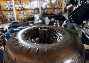 A car engine is being worked on inside a garage workshop