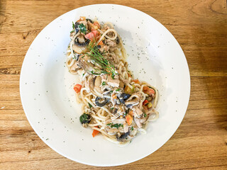 a plate of spaghetti with chicken and vegetables