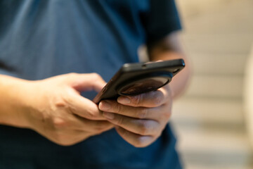 asian man using smart phone at night in city
