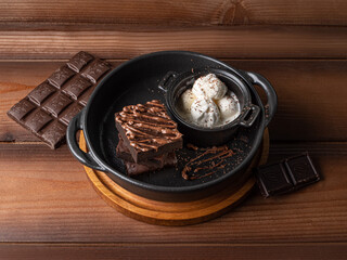 chocolate brownie dessert with a ball of ice cream