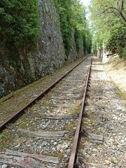 Ancient railway passing through limestones cliffs in Bouzies, near Cahors, France, with vanishing point