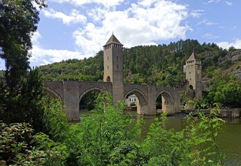 Panoramic view of Valentre Bridge on Lot river in Cahors, France. Medieval brige with towers.