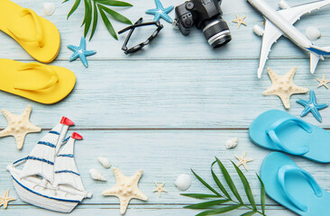 Summer vacation accessories forming a frame on wooden background