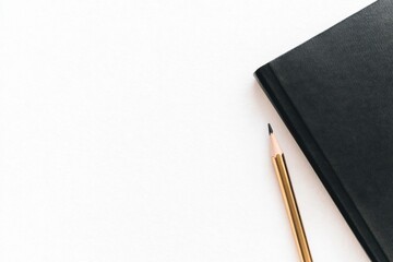A sharpened pencil lies next to a closed black notebook on a clean white surface.