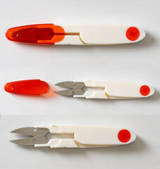 White plastic thread cutting scissors in a red case on a white background.  Sewing clippers tailor scissors tool. 